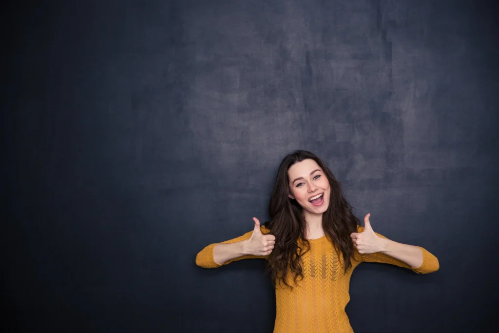 Cheerful-woman-showing-thumbs-up-508253570_3869x2579
